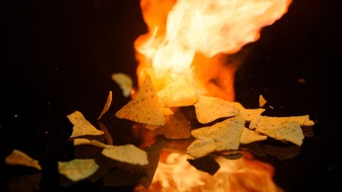 Nachos roasting on fire. Black background. Slow motion Stock Footage 92564744