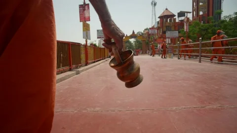 Naga Sadhus walking alone during Kumbh holding Kamandal in their hands Stock Footage 214324846