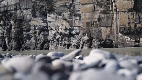 Nahanni River flows by rock cliffs Video stock 92364088