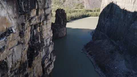 Nahanni River passes through a valley by a forest in Stock Footage 92363794