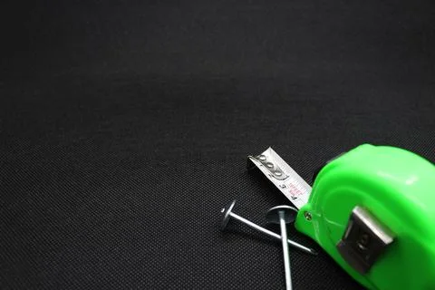 A nail and Building meter Stock Photos