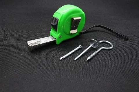 A nail and Building meter Stock Photos