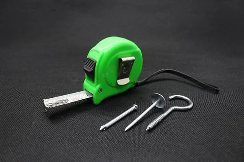 A nail and Building meter Stock Photos