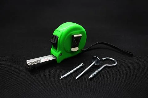 A nail and Building meter Stock Photos