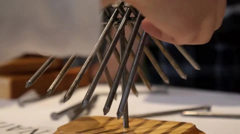 Nail balancing puzzle at a science fair. Stock Footage 50027489