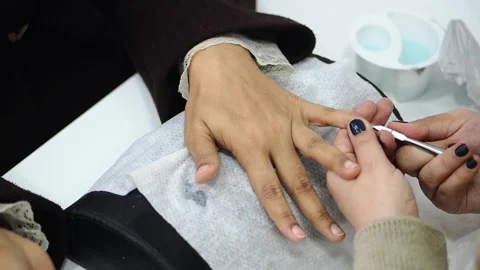 Nail care and manicure process at a salon in a busy city Stock Footage 345187440