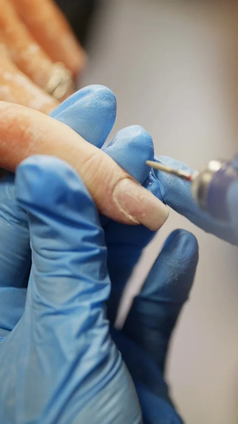 Nail Care Expert Using Electric Drill for Nail Preparation in Salon Beauty Stock Footage 317153178