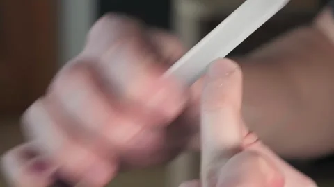 Nail care, a guy files his nails with a nail file Stock Footage 264884506