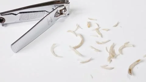 Nail clippings, small pieces of fingernails or toenails removed by clipper Stock Footage 304891169