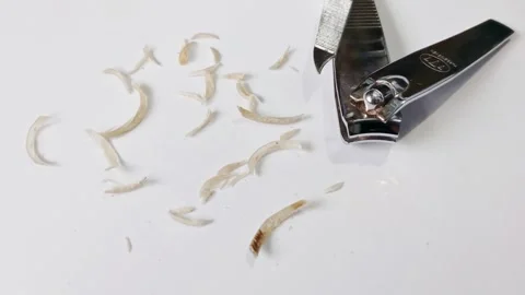 Nail clippings, small pieces of fingernails or toenails removed by clipper Stock Footage 304891309