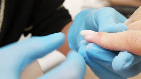 Nail file processing. Manicurist files the shape of the nails with a special  Stock Footage 155198753