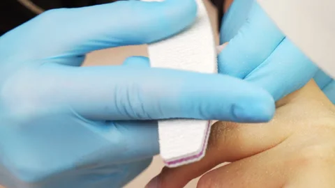 Nail file processing. Manicurist files the shape of the nails with a specia.. Stock Footage 265580524