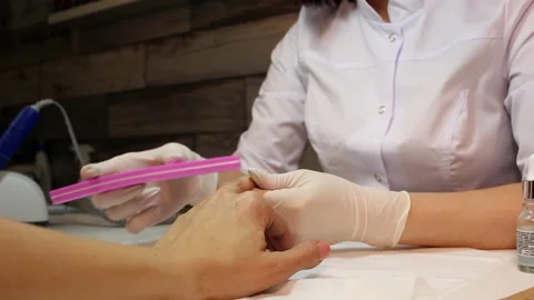 Nail file processing. The manicurist shapes the nails with a nail file. Stock Footage 170122828