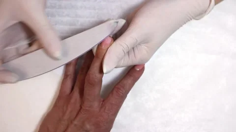 Nail file processing. The manicurist shapes the nails with a nail file. Stock Footage 170122892