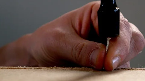 A nail is hammered in a flat pack Stock Footage 98663429