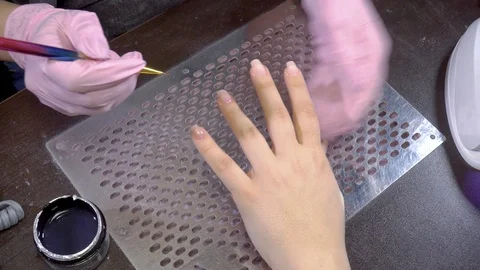 Nail master causes gel base on the girl's nails Stock Footage 103477315