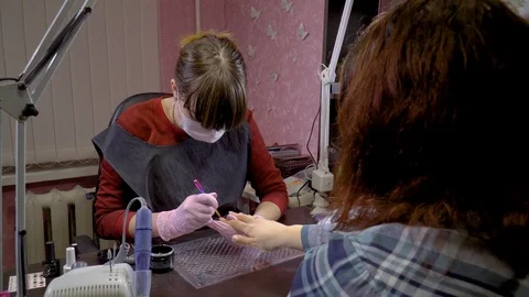Nail master causes gel base on the girl's nails Stock Footage 103732900