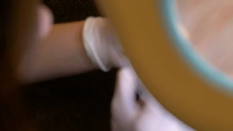 Nail master makes gold manicure above lens Stock Footage 79307388