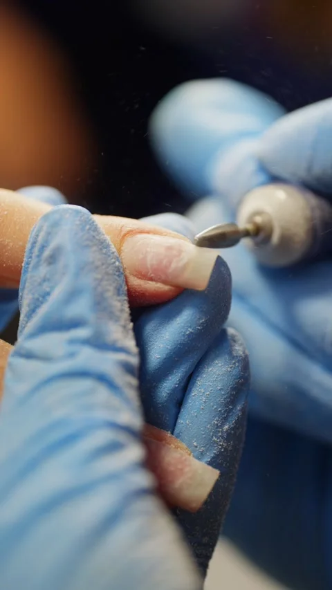 Nail master performing manicure procedure in a beauty studio shaping nails Video stock 319879615