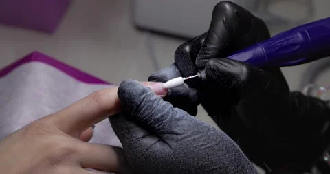 Nail master remove nail polish in beauty saloon with electric file nail. Stock Footage 192886828