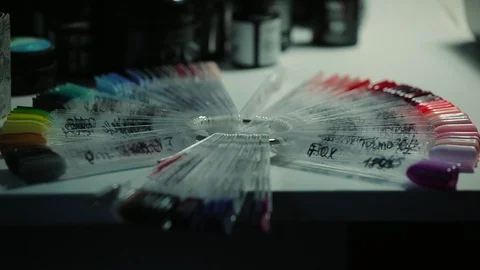 Nail paint design sample plate on the table in manicure cabinete Stock Footage 98713407