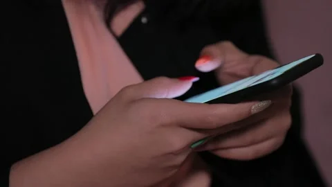Nail polished Hand of girl using smartphone in the living room at home, Stock Footage 148533732