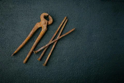 Nail puller and rusty nails on a black background Stock Photos