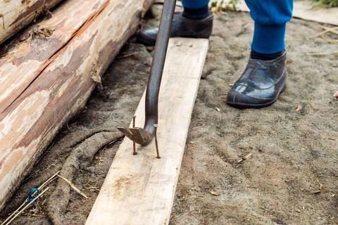 Nail puller close-up, on the street. Pulling out old nails Stock Photos