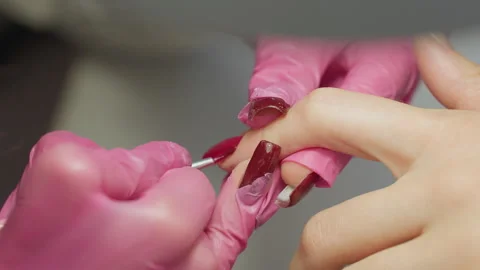 Nail Technician Using Tiny Brush to Apply Red Polish on Nail Edge Video stock 310270693