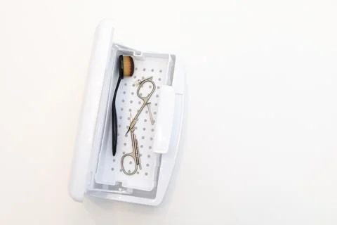 Nail tool sterilizer box, plastic sterilization tray, closeup sanitizing machine Stock Photos