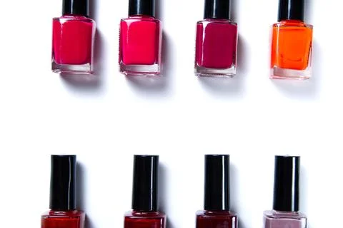 Nail work flat lay concept. bottles of colorful nail polish on white background Stock Photos