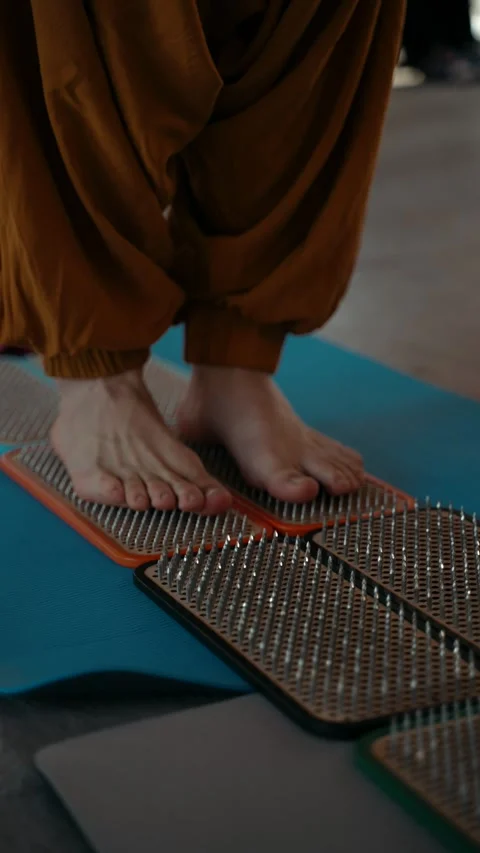 Nailing close-up people standing on nails Stock Footage 273950046