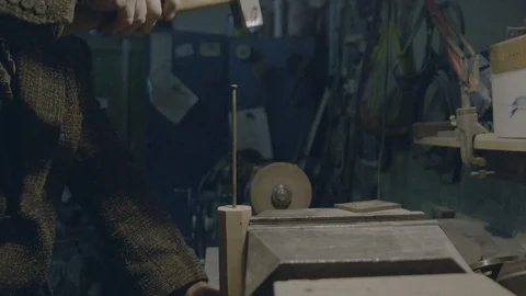 Nailing a nail with hammer in workshop Stock Footage 89613912