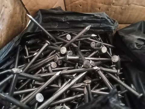 Nails in cardboard  Stock Photos