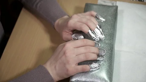 Nails of the customer in a foil Stock Footage 73416305