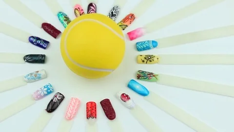 Nails examples around and tennis ball Stock Footage