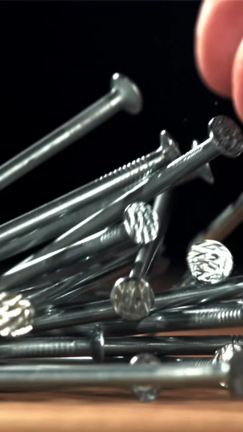 Nails fall on the carpenter's worktable. Filmed on a high-speed camera at 1000 Stock Footage 335374121