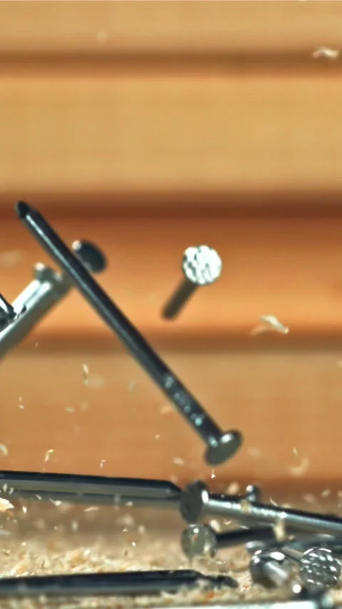 The nails fall on the master's desk. Filmed on a high-speed camera at 1000 fps Stock Footage 335364839