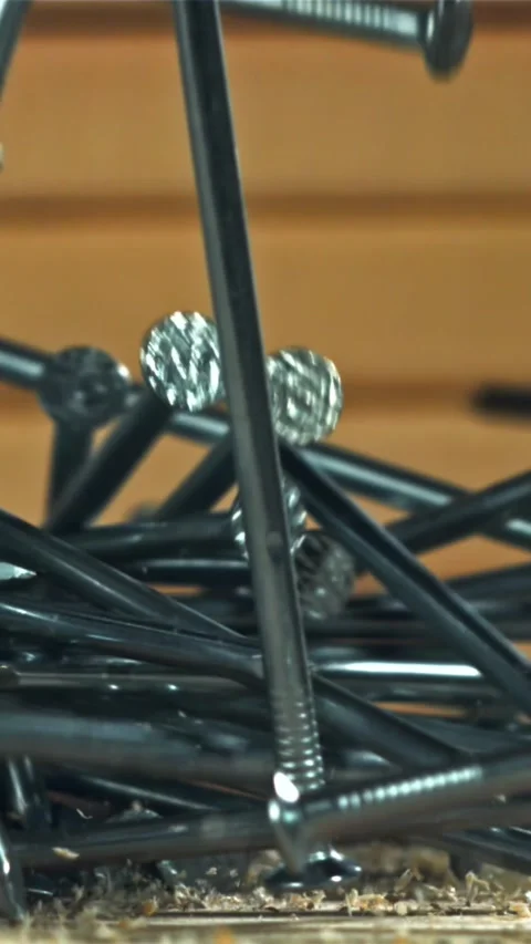The nails fall on the master's desk. Filmed on a high-speed camera at 1000 fps Stock Footage 335368963