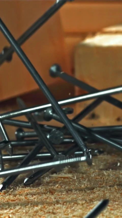 The nails fall on the master's desk. Filmed on a high-speed camera at 1000 fps Stock Footage 335370866