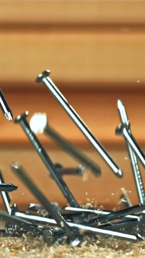 The nails fall on the master's desk. Filmed on a high-speed camera at 1000 fps Stock Footage 335372639