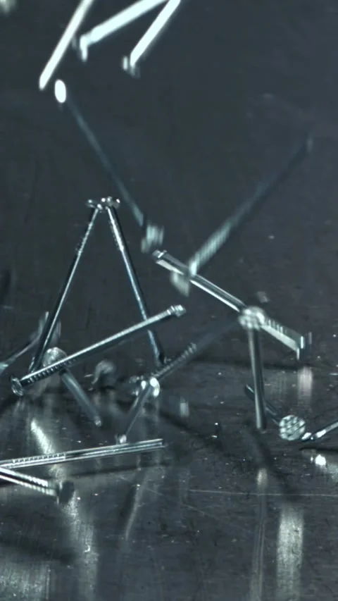 Nails fall on a metal table. Filmed on a high-speed camera at 1000 fps Stock Footage 335363091
