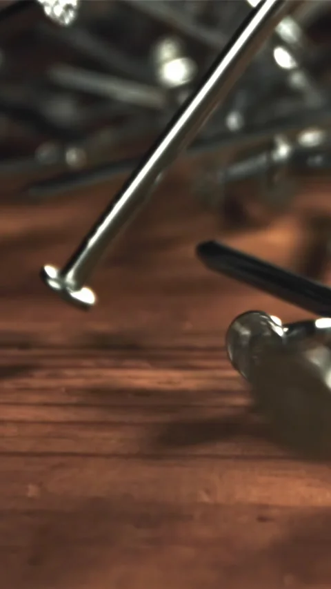 Nails fall on a wooden table. Filmed on a high-speed camera at 1000 fps Stock Footage 335370788