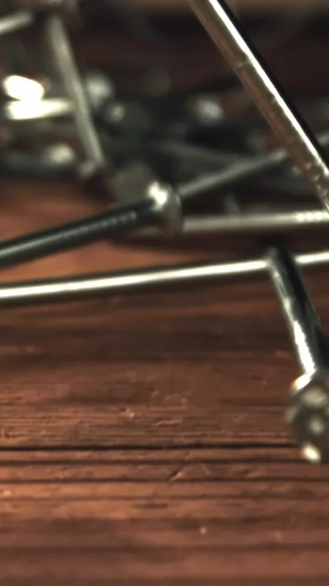 Nails fall on a wooden table. Filmed on a high-speed camera at 1000 fps Stock Footage 335375964