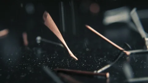 Nails falling on the black table on black bg in slow motion Stock Footage 103112296
