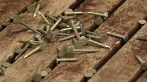 Nails Falling onto a Wooden Table Closeup. Stock Footage 69142772
