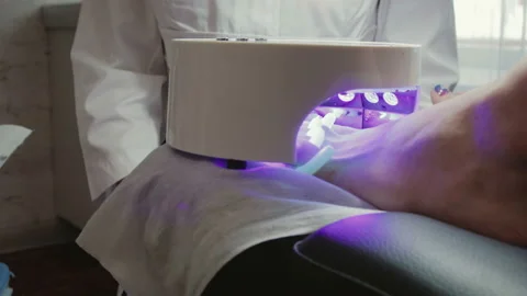 The nails on the model's foot are dried using led lamp, nail dryer 스톡 동영상 101064279