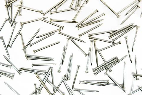 Nails spread out on a white surface Foto stock