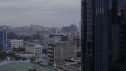 Nairobi, Low drone shot tracking city building with reflections of sunset Stock Footage 147792916