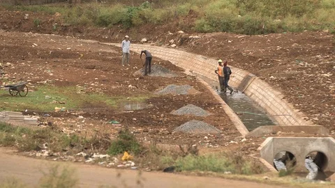 Nairobi Men Working by the Road Stock Footage 107791358
